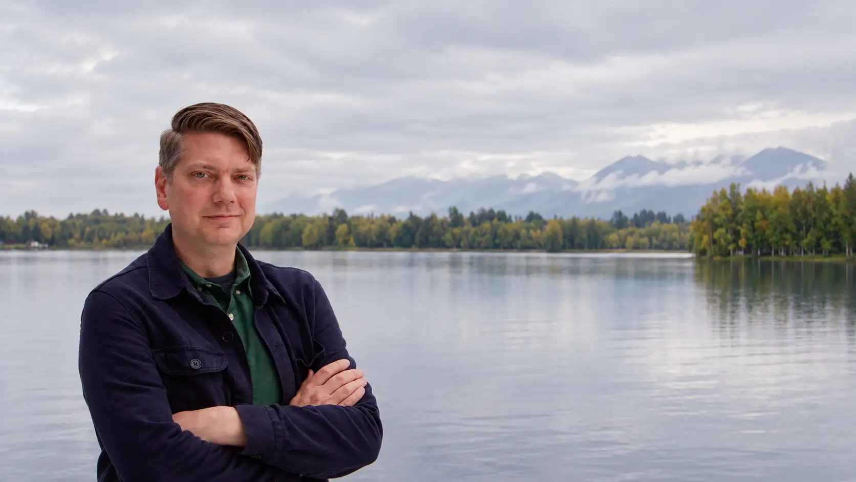Congressman Nick Begich standing by an Alaska lake
